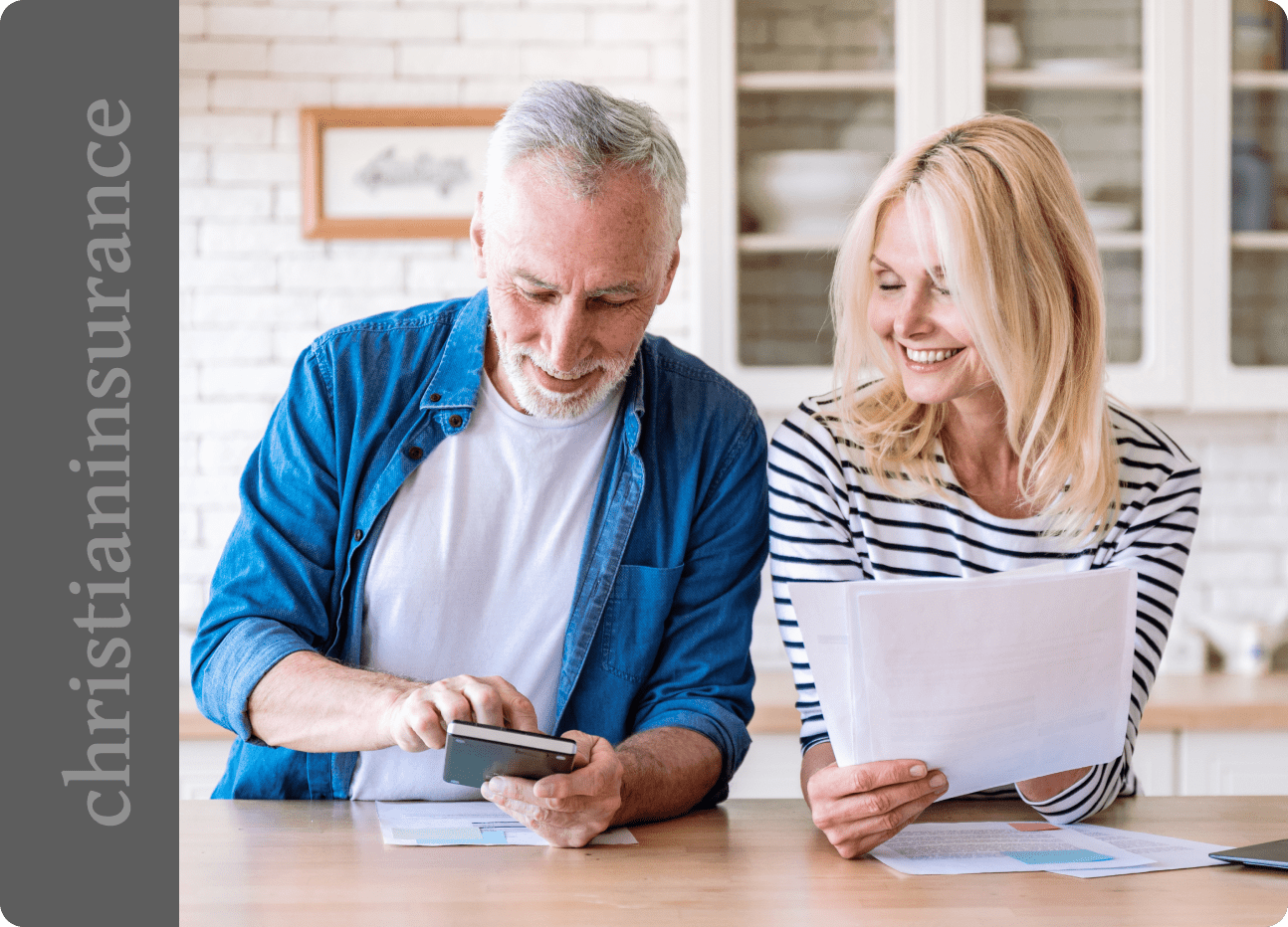 Older couple reviewing documents in kitchen.