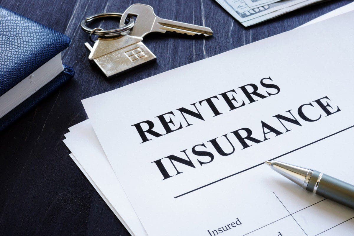Renters insurance document with house keys.
