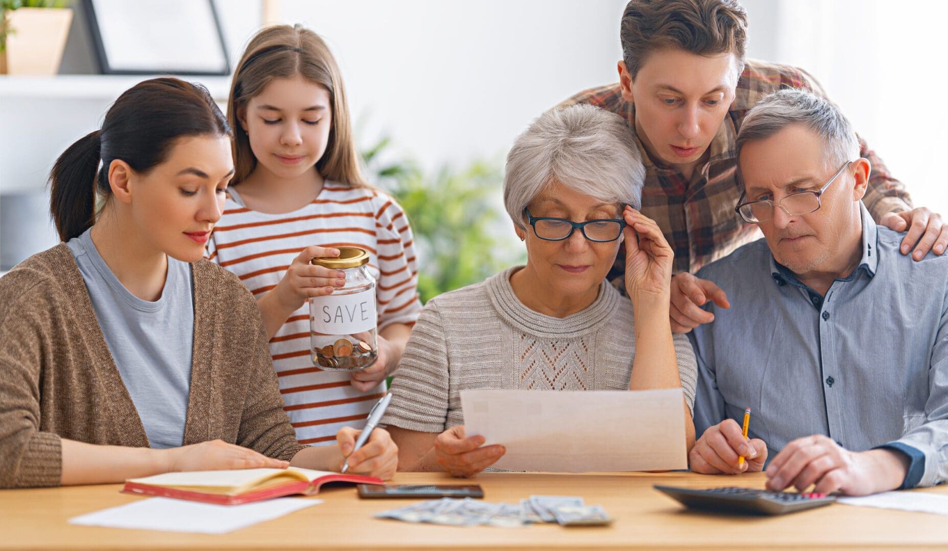 Family budgeting together at a table.