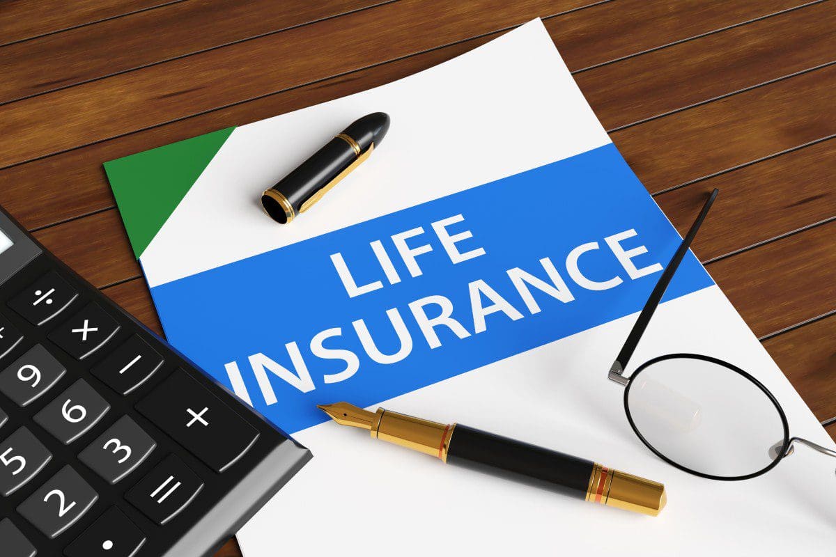 Life insurance document with pen and calculator.