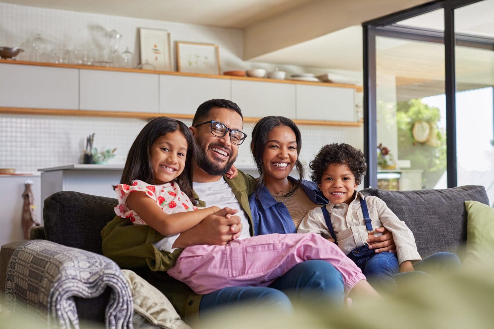 Happy family sitting together on a couch.