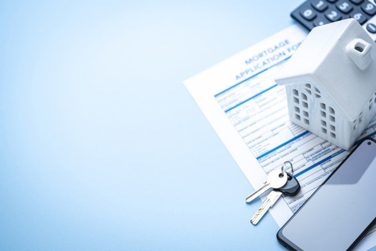 Mortgage application with keys and house model.