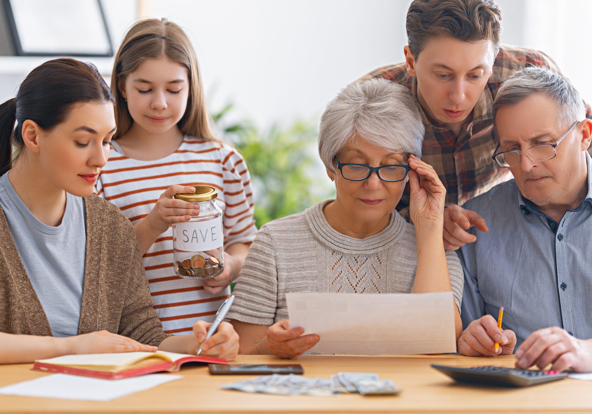 Family budgeting together at a table.
