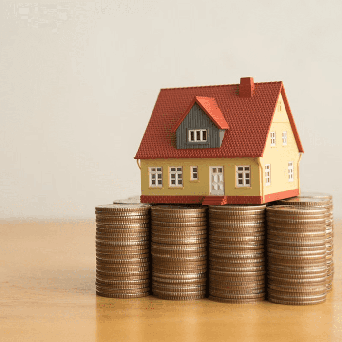 House model on stacks of coins.